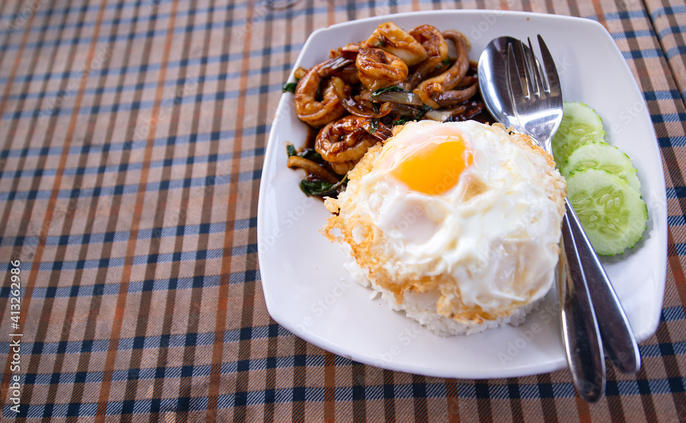 Stirred-fry shrimps or prawns with basil leaves, fried egg over rice. hot and spicy Stirred-fry shrimps or prawns with basil leaves, fried egg over rice. hot and spicy