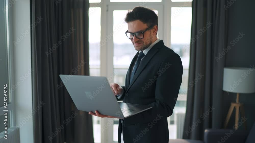 Caucasian man dressed in a jacket and underwear using laptop to make a video call from home in a modern apartment. Remote work during a pandemic Caucasian man dressed in a jacket and underwear using laptop to make a video call from home in a modern apartment. Remote work during a pandemic
