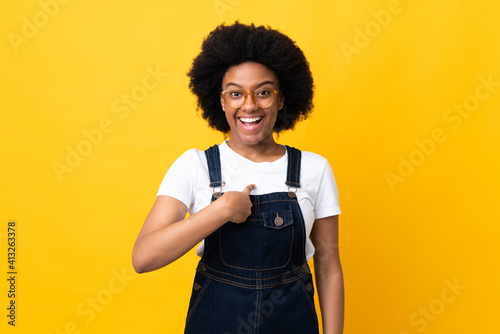 Young African American woman isolated on yellow background with surprise facial expression