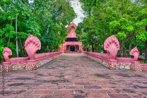 Samut Sakhon / Thailand / August 30, 2020 : Wat Pa Chai Rangsi, The temple was built in 1982. The architect combined a variety of architectural styles. . Serpent statue in the park. photo