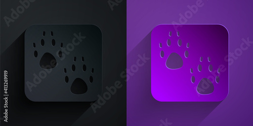 Paper cut Paw print icon isolated on black on purple background. Dog or cat paw print. Animal track. Paper art style. Vector.