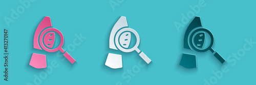 Paper cut Magnifying glass with footsteps icon isolated on blue background. Detective is investigating. To follow in the footsteps. Paper art style. Vector.