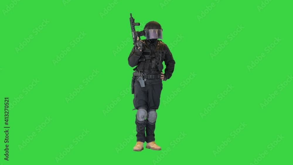 Policeman in protective cask with a rifle raised up on a Green Screen, Chroma Key. Policeman in protective cask with a rifle raised up on a Green Screen, Chroma Key.