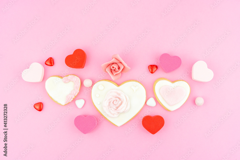 Heart shape pink, white and red cookies. Decorated heart shaped and rose cookies on pink background, flat lay with space for text. Marshmallow, Biscuit and Candy sweets. Valentine's day concept.