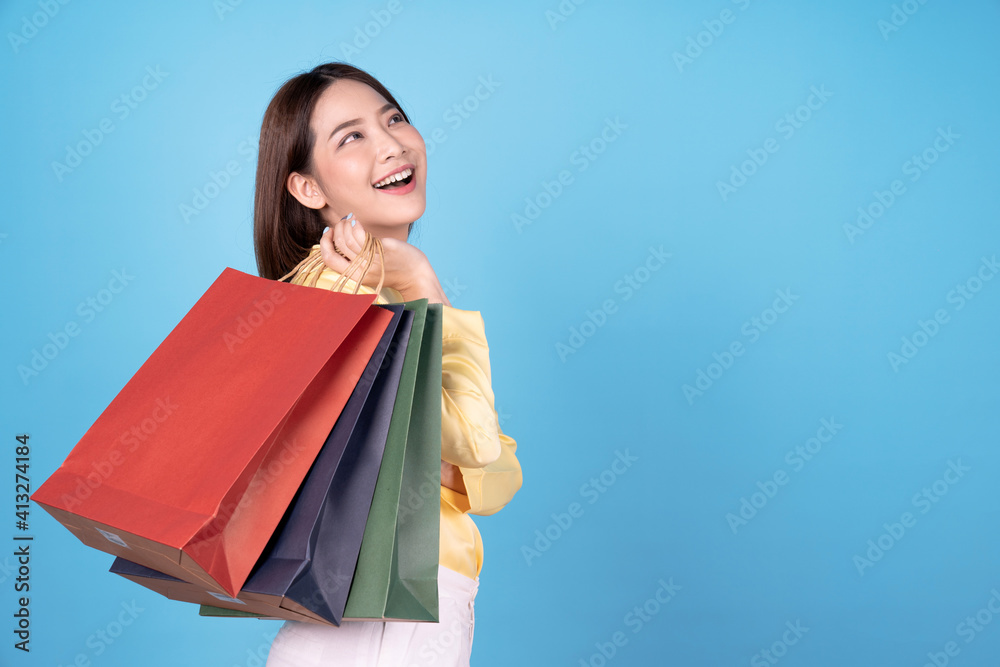 Young asian women are happy to go shopping, isolated on blue background. Young asian women are happy to go shopping, isolated on blue background.