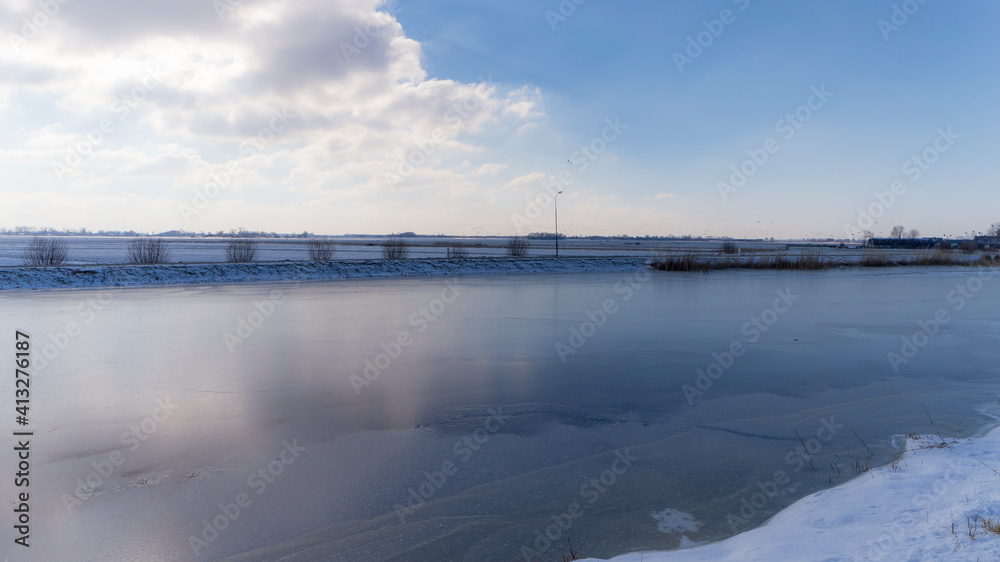 Frozen Holendrecht river in the winter