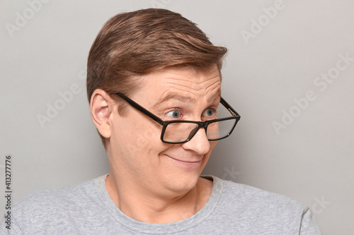 Portrait of happy mature man looking over his glasses to the side