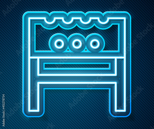 Glowing neon line BBQ brazier icon isolated on blue background. Vector.