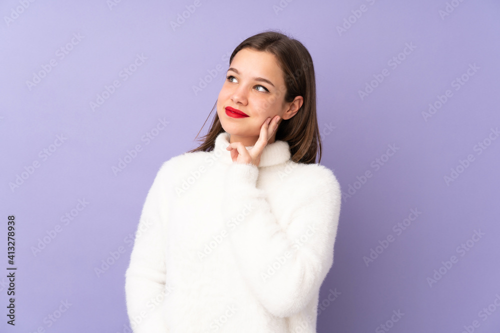 Teenager girl isolated on purple background thinking an idea while looking up Teenager girl isolated on purple background thinking an idea while looking up