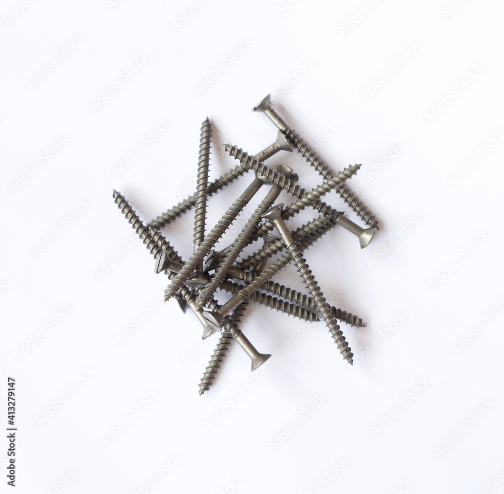 Pile of grey metal wood screws on plain white background Pile of grey metal wood screws on plain white background