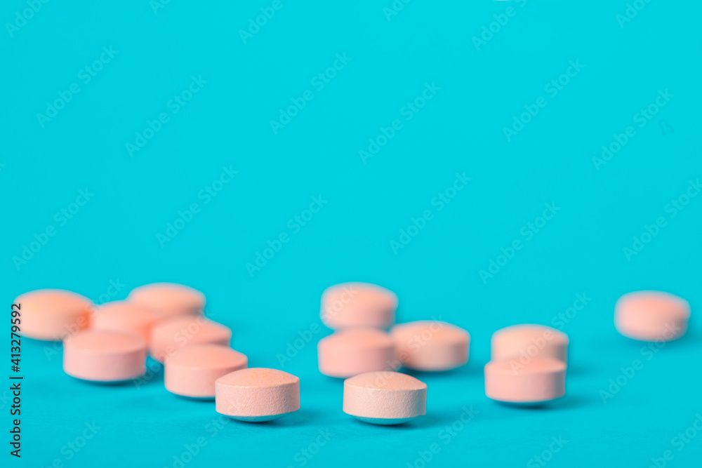 Pink  pills on blue background. Antibiotics drug resistance. Antimicrobial capsule pills. Pharmaceutical industry. Healthcare and drugstore. Pharmaceutics concept. Drug in hospital. 