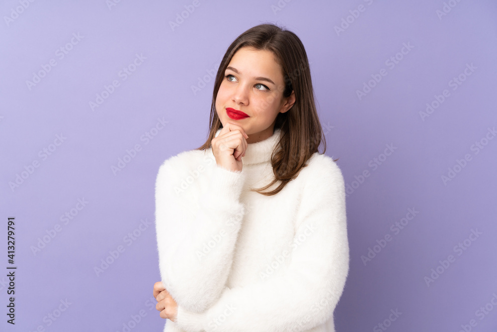Teenager girl isolated on purple background looking to the side Teenager girl isolated on purple background looking to the side