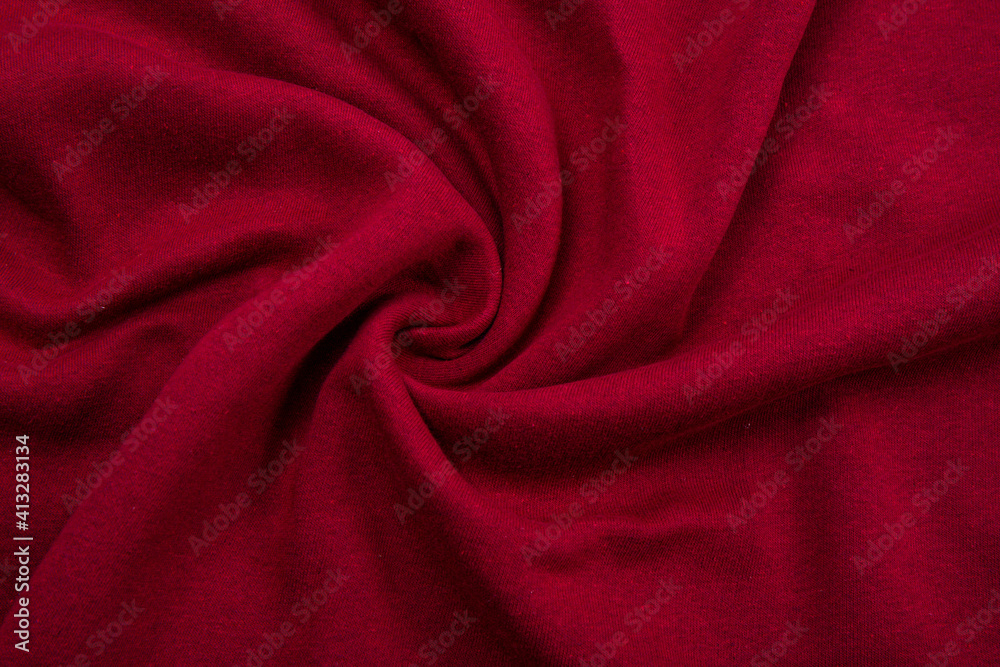 Pleats on fabric, knitted material of Crimson color, folds Pleats on fabric, knitted material of Crimson color, folds