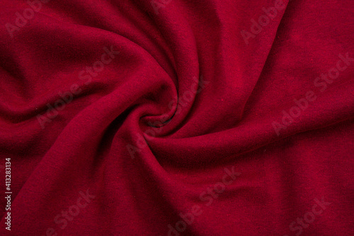 Pleats on fabric, knitted material of Crimson color, folds