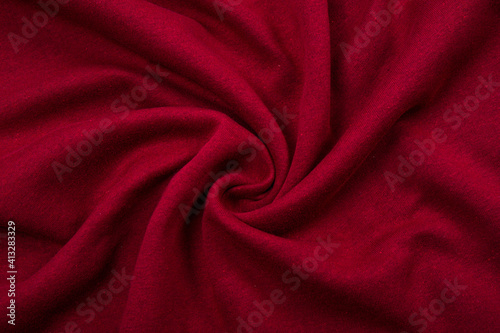 Pleats on fabric, knitted material of Crimson color, folds