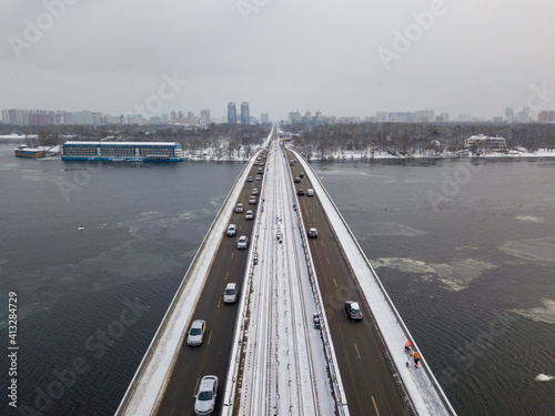 Snow-covered metro bridge in Kiev. Cloudy winter morning. Aerial drone view. © Sergey