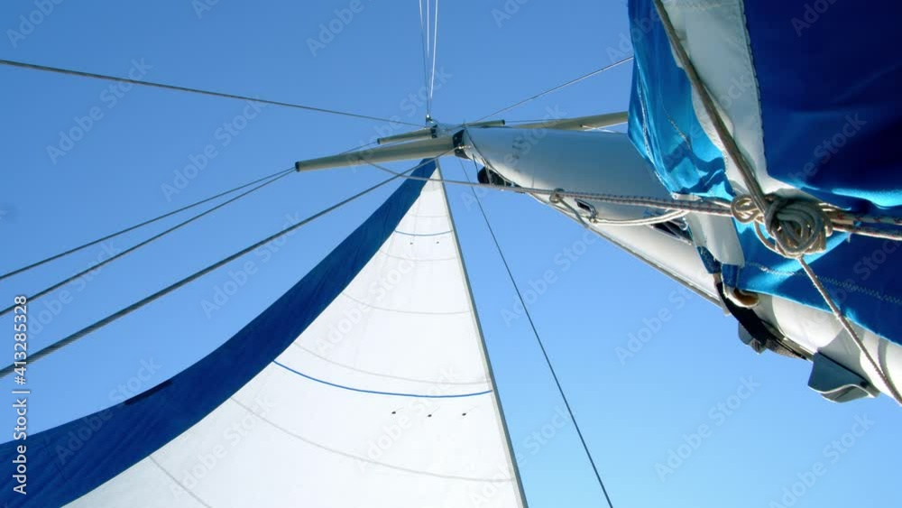 Nautical vessel. A sailboat mast and jib seen from below. 4k slow motion