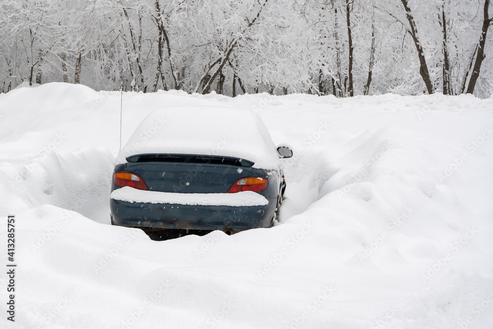 Car in the parking lot in winter, big snowdrifts around Car in the parking lot in winter, big snowdrifts around
