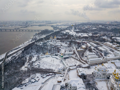 View of the Dnieper and the snow-covered right bank of Kiev. Aerial drone view. Winter snowy morning.