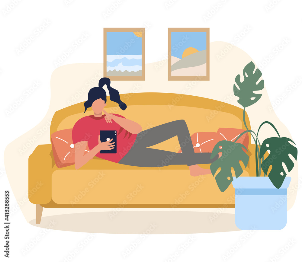 Fototapeta premium The girl is lying on the couch with a tablet in her hands, work online, training online. Relaxing on the couch