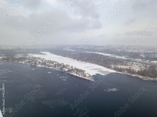 The Dnieper River in Kiev in a blizzard. Aerial drone view. Frosty winter cloudy morning.
