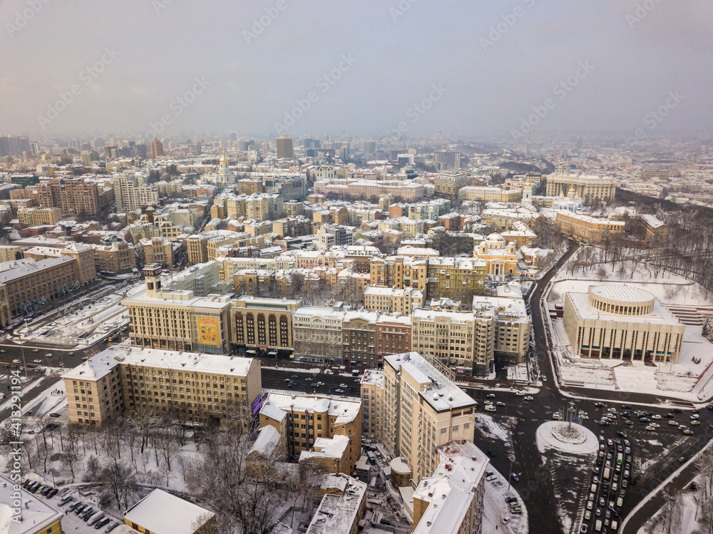 Kiev covered with snow. Aerial drone view. Frosty winter cloudy morning.