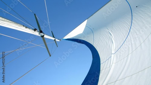 Nautical vessel. A sailboat mast and jib seen from below. 4k slow motion