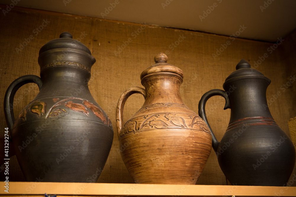 russian traditional pottery on a shelf in a workshop russian traditional pottery on a shelf in a workshop