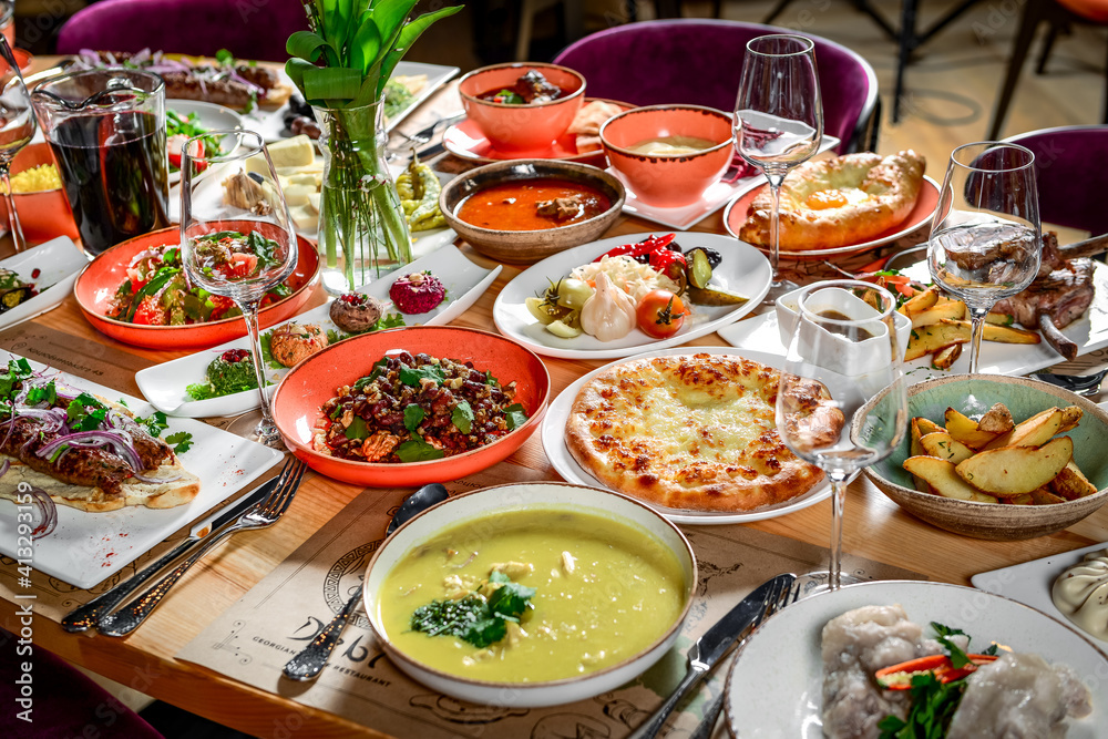 Georgian cuisine. A large laid table of different dishes Georgian cuisine. A large laid table of different dishes