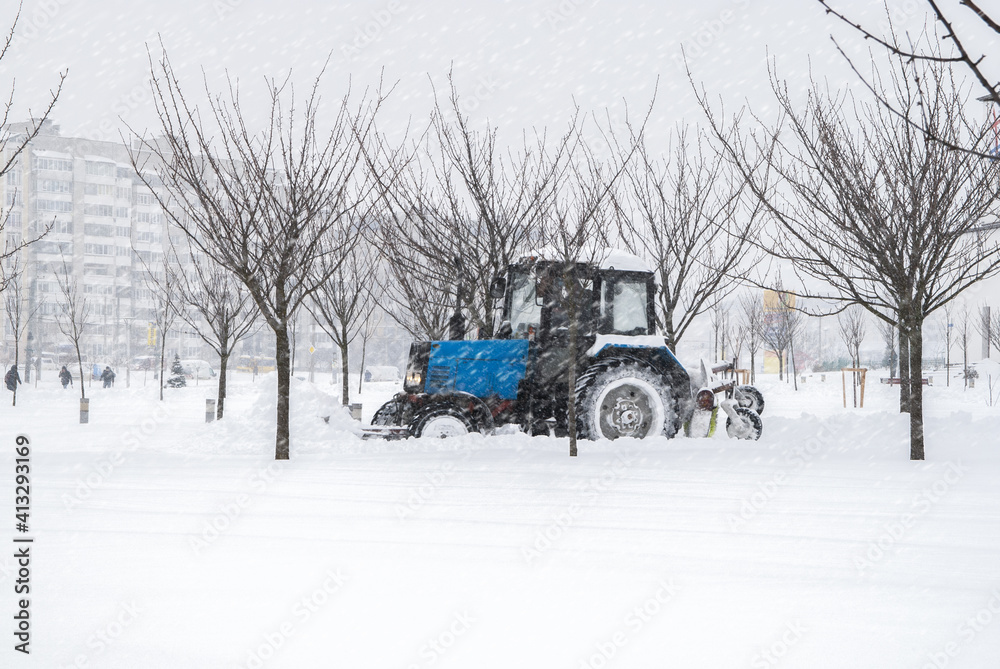 Snow-covered street. Snowplow removing snow from city road. Heavy snowstorm, blizzard traffic. Climate weather disaster. Winter urban scene. Snowdrifts after a snowfall Snow-covered street. Snowplow removing snow from city road. Heavy snowstorm, blizzard traffic. Climate weather disaster. Winter urban scene. Snowdrifts after a snowfall