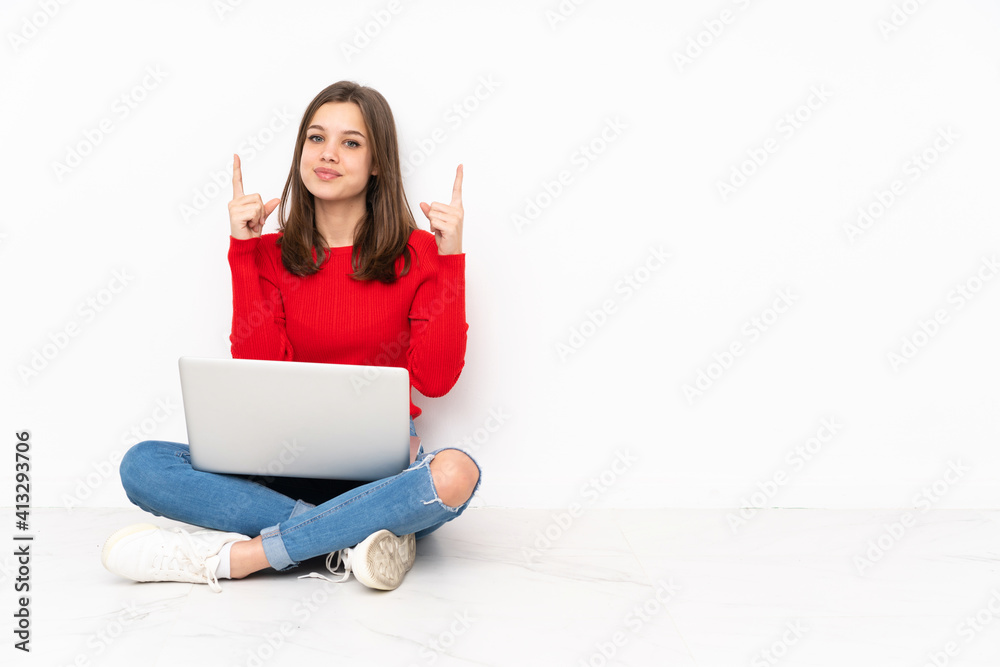 Tenaager girl working with pc isolated on white background pointing up a great idea Tenaager girl working with pc isolated on white background pointing up a great idea