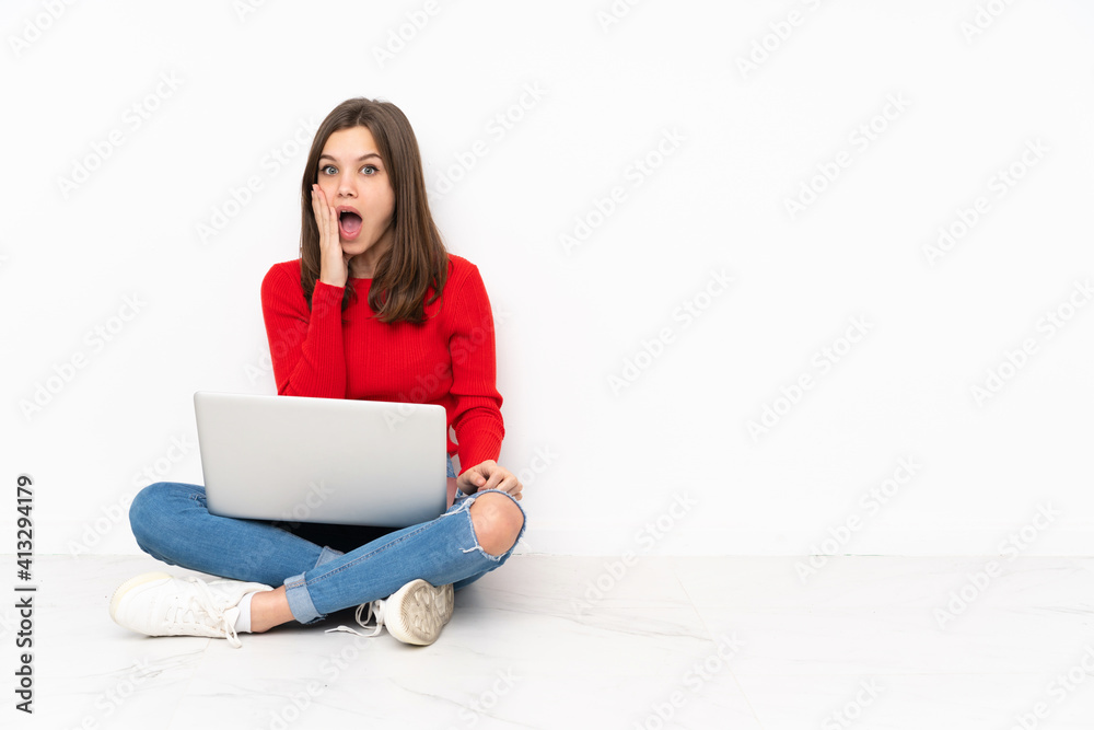 Tenaager girl working with pc isolated on white background with surprise and shocked facial expression Tenaager girl working with pc isolated on white background with surprise and shocked facial expression