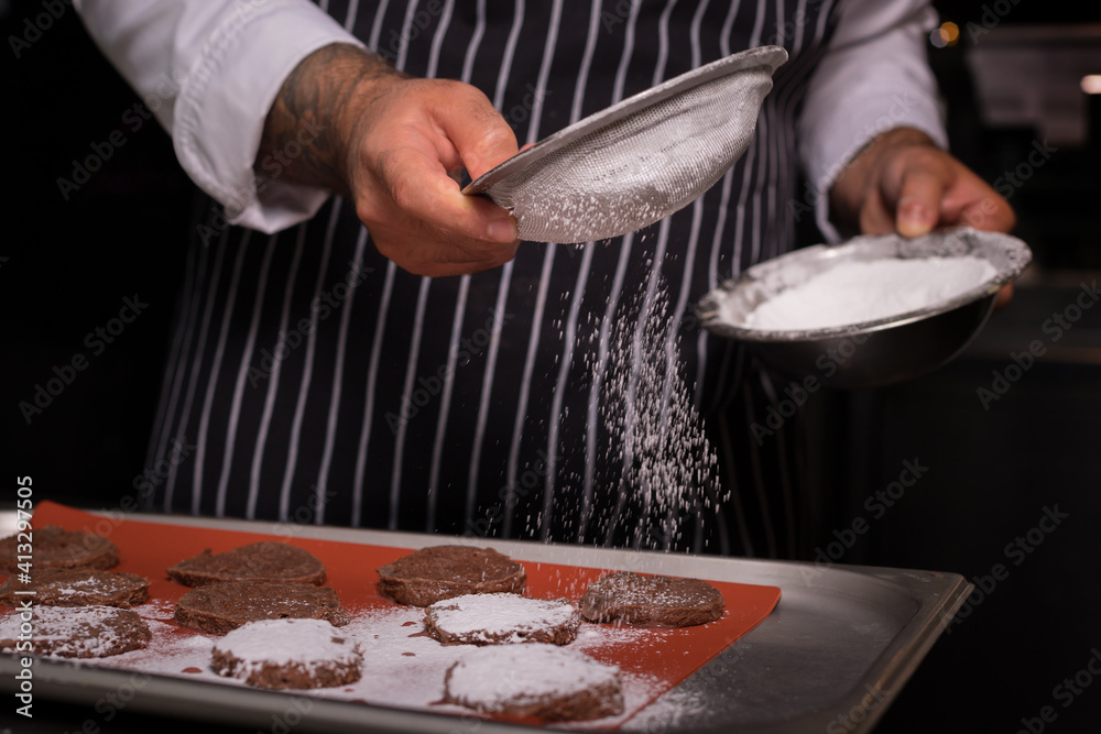 Chef preparing cookies in his kitchen. Chef preparing cookies in his kitchen.