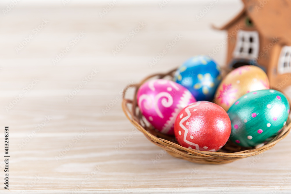 Five easter eggs trendy colored deep blue, green, orange, magenta and golden decorated in basket on white background. Copy space for text. Five easter eggs trendy colored deep blue, green, orange, magenta and golden decorated in basket on white background. Copy space for text.