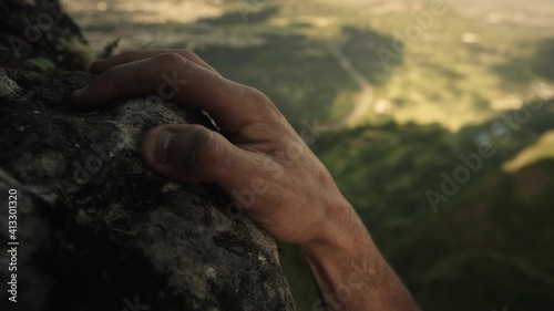 Rock climbing closeup on male hand