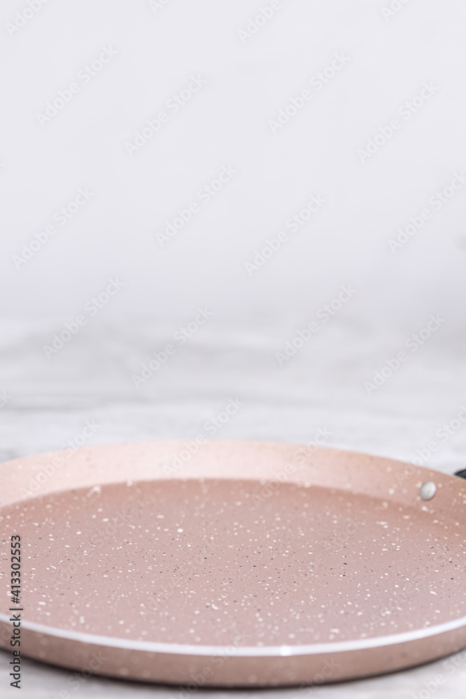 Fototapeta premium New frying pan on the grey marble table