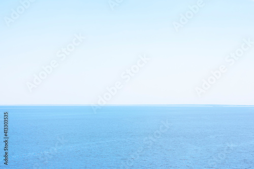 Background made of landscape with blue calm water of sea or ocean and clean sky. Copy space, blank