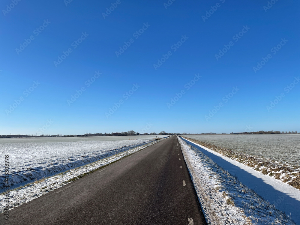 Empty road in a winter landscape around Sneek