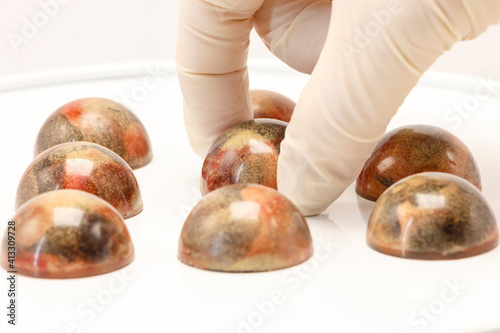 The chocolatier lays out handmade bonbons.