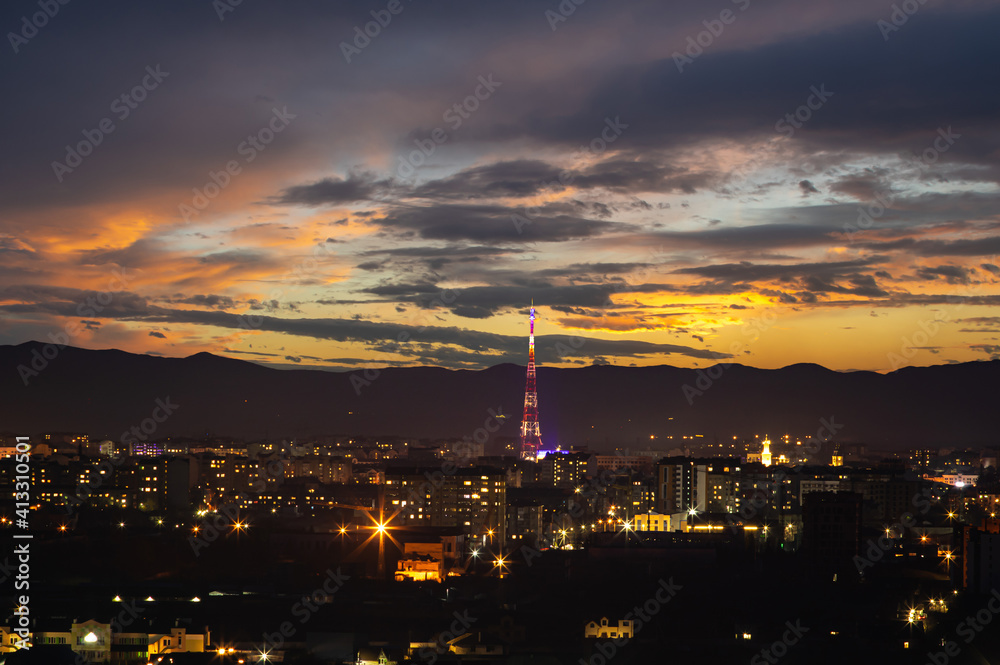 Naklejka premium TV tower in the Ukrainian city at sunset