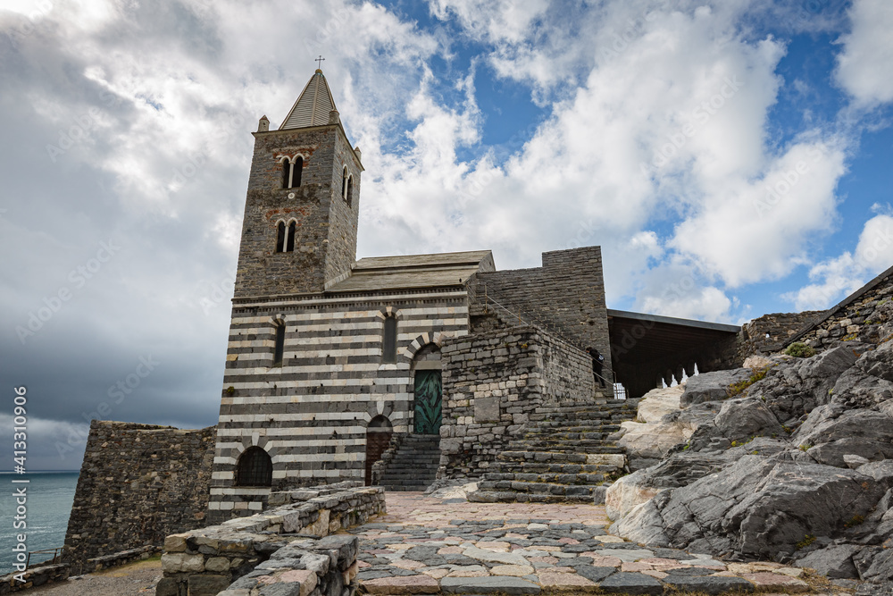Cityscape. View of the stone stairway leading to the Church of St Peter with cloudy sky background in Portovenere (Porto Venere) Italy