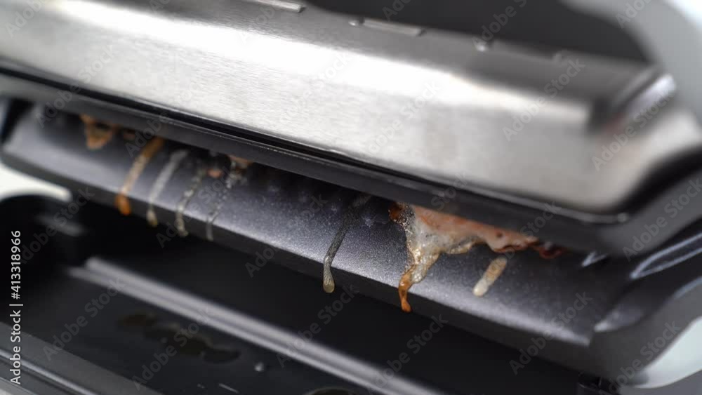 fat drips off while cooking on an electric grill. fat drips off while cooking on an electric grill.
