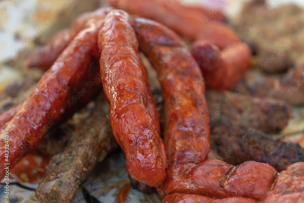 Fototapeta premium Grilled sausage dish on charcoal