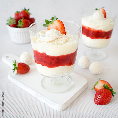 Coconut dessert with strawberry mousse. Fluffy cream with Raffaello balls  white chocolate and fresh strawberries.
