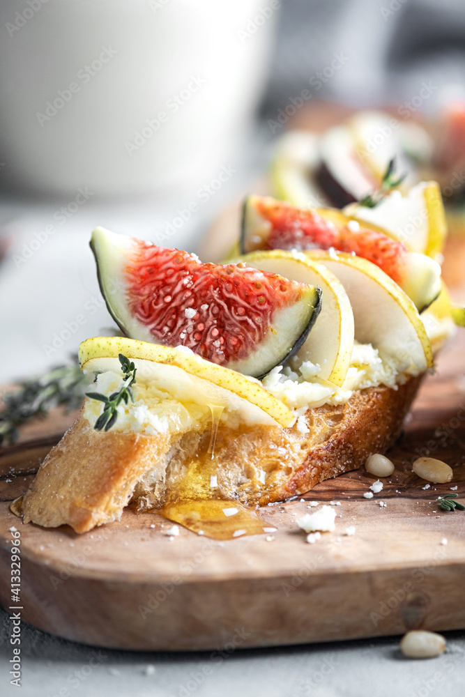 Canape or crostini with toasted baguette, cheese, onion jam, figs and