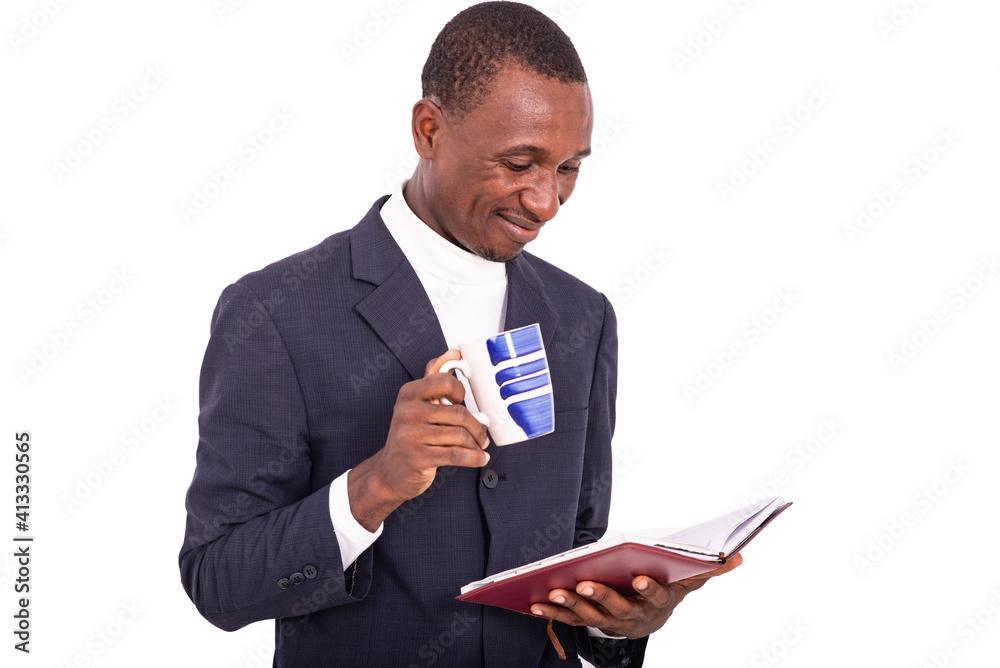 Close-up of a handsome businessman with diary and cup of coffee, smiling. Close-up of a handsome businessman with diary and cup of coffee, smiling.