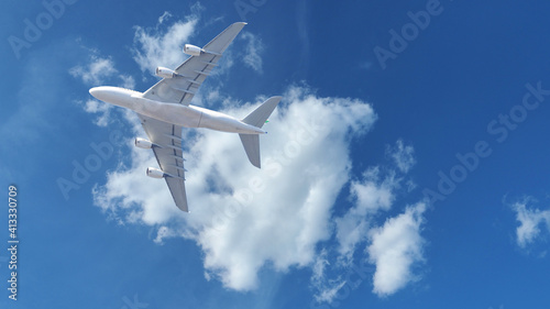 Zoom panoramic photo of passenger plane flying above deep blue slightly cloudy sky
