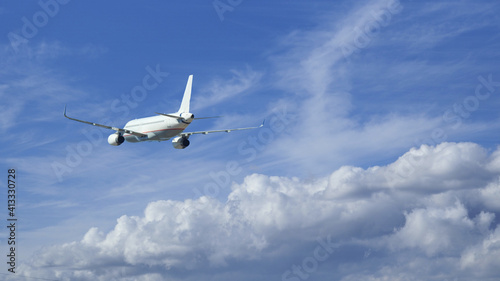 Zoom photo of passenger airplane taking off in deep blue cloudy sky