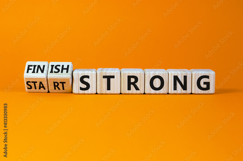 © Dzmitry - Start and finish strong symbol. Turned wooden cubes, changed words 'start strong' to 'finish strong'. Beautiful orange background, copy space. Business and start and finish strong concept.