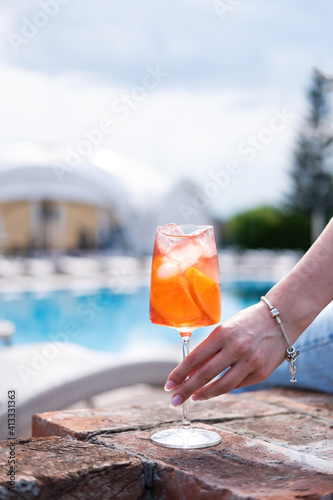aperol cocktail with ice in the hand